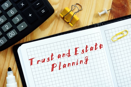 The inscription Trust and Estate Planning on a notebook sheet