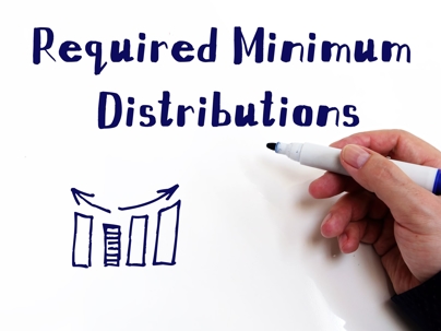 Closeup of hand writing Required Minimum Distribution in marker