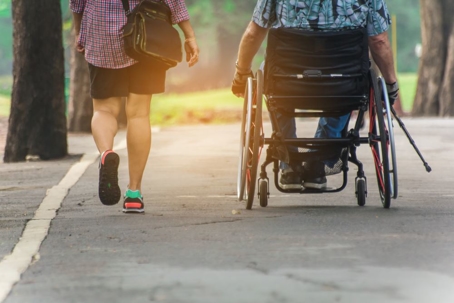 A man on wheelchair and his wife enjoying in the park