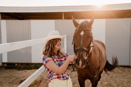 Young woman with cerebral palsy in therapy with a horse