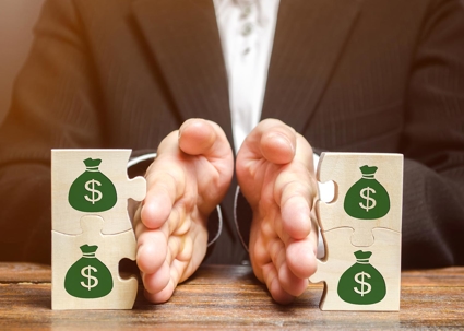 image of hands separating blocks with money bags on them.