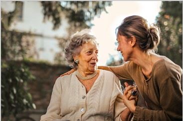 two women talking outside