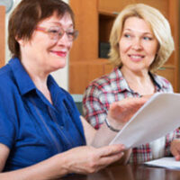 women looking at paperwork