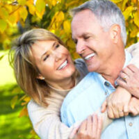 happy elder couple hugging