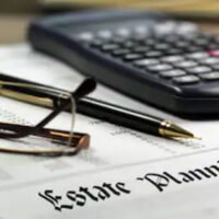 estate planning document below a calculator and pen